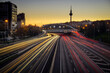 © cribea - Traces of car lights at dusk driving along the Madrid ring road with the Piruli in the background