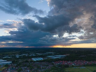 Wall Mural - Drone timelapse of dramatic sunset cloudscape over a cityscape view