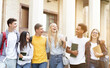 © Prostock-studio - Happy students walking together in campus, having break in university