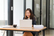 © Wicitr - Focused Asian Businesswoman at Work