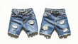 © Elnare - Two pairs of ripped denim shorts lay flat on a white background.