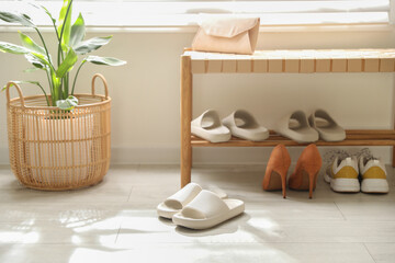 Wall Mural - Many pairs of slippers and other shoes in entryway at home