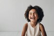 © Michael - Joyful Portrait of a Playful Mixed Race Girl Smiling on a Simple White Background