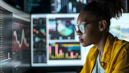 Poster - Focused individual analyzing data on multiple screens in a modern office, showcasing technology and productivity.