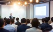 © 为轩 张 - Asian business training presentation in a modern office, audience seated and listening to the speaker with light bulb pendant lights, whiteboard, and laptop displaying PowerPoint content.