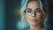 © CreativeIMGIdeas - A woman with glasses and a blue eye is looking at the camera
