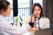 © N_studio - Young asian patient woman consulting with doctor in coat about wrinkle and skin for rejuvenate and beauty while watching laptop in modern medical office, doctor explaining and diagnostic facial.