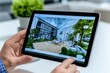 © Sanchai - A close-up of a real estate agentâ€™s tablet, showing a digital property listing with floor plans and virtual tours