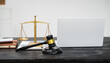 © NanSan - A lawyer's desk in an office,with legal documents, computers, and hammers placed neatly.The setting is organized for legal consulting services, contract reviews,will drafting,document certification