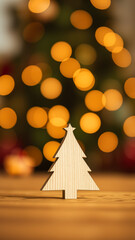 Wall Mural - Wooden Christmas Tree Ornament Against Blurred Lights