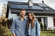 © Panuwat - Man woman standing front modern house solar panels Happy couple sustainable home