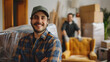 © SS Digital - Portrait of a two young smiling male movers packing furniture in the living room. Moving service men workers wrapping chair with plastic wrap. Move, moving day and relocation concep