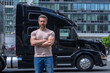 © Volodymyr - Truck driver. CDL. Portrait of trucker standing by his truck vehicle ready for transport. Male driver standing in front on his truck.