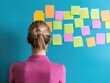 © banthita166 - Woman brainstorming ideas with colorful sticky notes