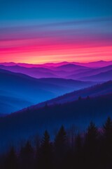 Wall Mural - Vibrant sunset over layered mountains viewed from a high vantage point, showcasing a spectrum of colors during twilight