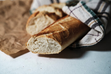 french baguette fresh, cut in slices, in kitchen textile cloth, rustic sryle