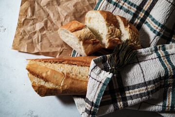 french baguette fresh, cut in slices, in kitchen textile cloth, rustic sryle