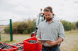 © Halfpoint - Male viticulturist overseeing grapes harvesting . Manual grape harvesting in family-run vineyard.