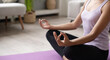 © kite_rin - Woman meditating in the lotus position closeup. Beautiful girl doing exercises at home. Harmony, balance, meditation, relaxation, healthy lifestyle, mindfulness concept