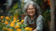 © Wiseman - senior woman in garden at home watering vegetables