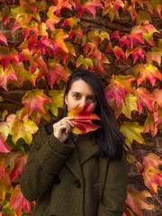 Wall Mural - Stylish Woman in Autumn Foliage