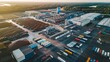 © Deedyy - A drone view of a large manufacturing plant, showcasing the layout of different sections including storage areas, assembly lines, and loading docks