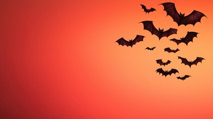 A group of bats flying against a vibrant orange sunset, creating a spooky and atmospheric scene typical of Halloween themes.