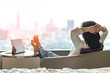 © Chinnapong - Simple lifestyle take it easy relaxation of Asian businesswoman, healthy woman resting in comfort business hotel or city home living room having lazy free time with peace of mind and work-life balance