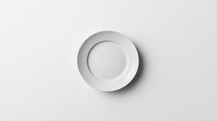 A white ceramic plate with a smooth finish lies flat in the center, standing out against the white background.