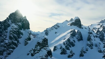 Aufkleber - Snow capped mountains with rocky cliffs and thick snow blanket create stunning winter landscape, reaching high into sky, surrounded by cold atmosphere