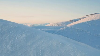 Poster - Smooth, sparkling snow blankets two hills, untouched and sparkling in the winter sun, creating a serene and picturesque winter landscape