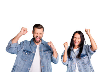 Poster - Portrait of cheerful people screaming yeah raising their fists closing eyes wearing denim jeans isolated over blue background
