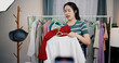 © Johnstocker - Portrait of Cheerful woman influencer is live streaming sell clothes on social media or blogging in home studio. Remote buying, Online shopping, Sell ​​products online