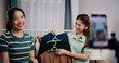 © Johnstocker - Portrait of Two cheerful woman influencers are live streaming sell clothes on social media or blogging in home studio. Remote buying, Online shopping, Sell ​​products online