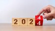 © Galeno - year strategy target planning business goal new year hand pushes wooden cubes red calendar showing symbolizing new startup next year