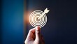 © Galeno - hand holding target representing achieving goals business objective planning