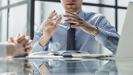 Two business men sit at desk discuss project details sales manager makes commercial offer to company client