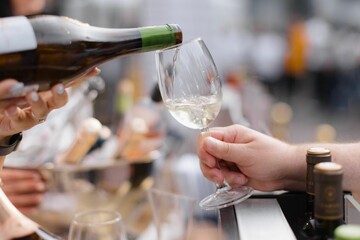 Pouring white wine at an outdoor event