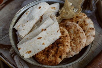 Assorted flatbreads in a rustic bowl