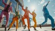 © VK Studio - A group of energetic individuals dressed in vivid suits dancing joyfully in an urban setting under the bright sunlight.