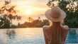 © CinimaticWorks - peaceful sunset by the pool with a woman in a straw hat enjoying the view and serene vacation in a tropical luxury resort capturing the perfect travel moment