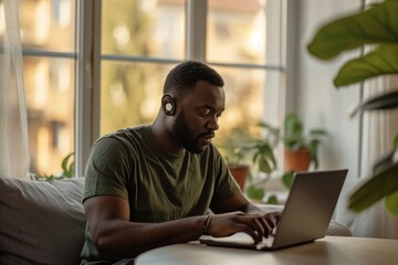 Sticker - Black man typing on his laptop computer sitting window.