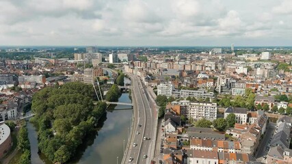 Wall Mural - Ghent, Belgium. Esco (Scheldt) river embankment. Panorama of the city from the air. Cloudy weather, summer day, Aerial View