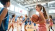 © Morning - A young girl smiles while holding a basketball during a game with teammates.