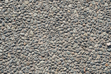 A high-resolution image of a seamless texture of small grey pebbles embedded in concrete. Perfect for backgrounds, website designs, and print projects.