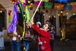 © Marcos - Mexican woman and family breaking a piñata at traditional posada party for Christmas in Mexico Latin America, hispanic people