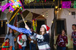 © Marcos - Mexican woman and family breaking a piñata at traditional posada party for Christmas in Mexico Latin America, hispanic people