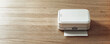 © Michael - A small, white mobile portable printer on wood surface with copy space