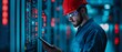 © javu - Engineer in red hard hat checks data on digital tablet in modern server room.