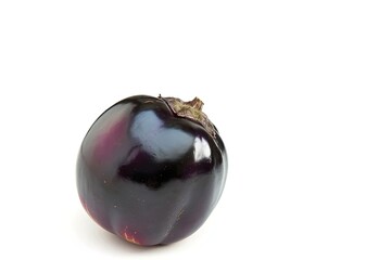 A black plum or round eggplant on a white background